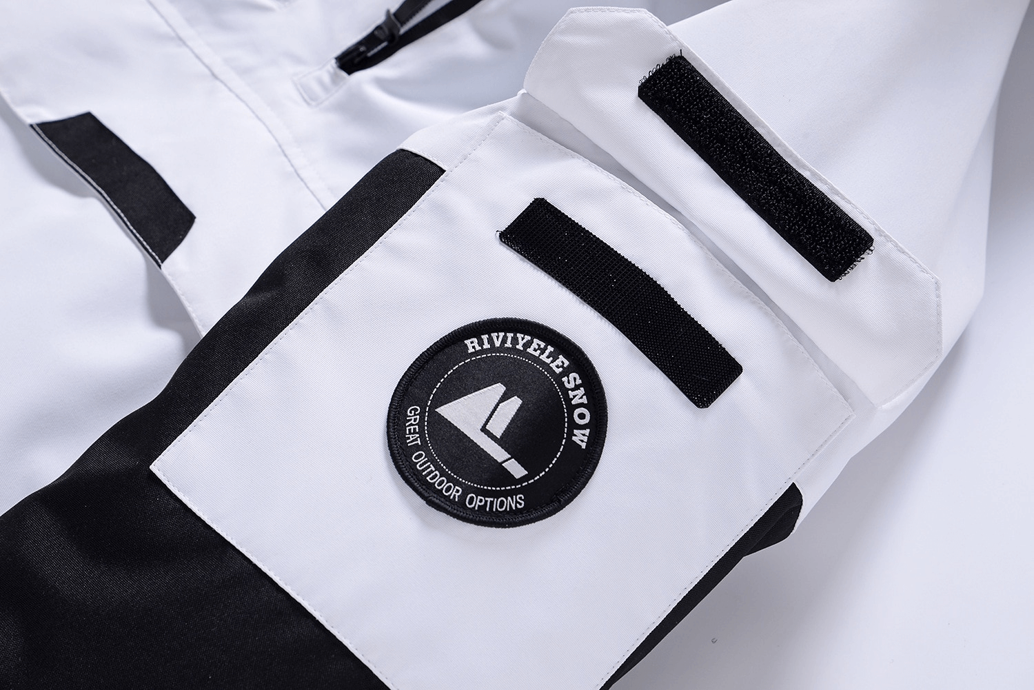 Close-up of Fashion Unisex Ski Jacket with Hood, featuring Riviele Snow logo and stylish black-and-white design for outdoor adventures.